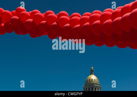 Ballons rouges voler au-dessus de la coupole de l'Édifice de la capitale de l'État du Colorado à Denver PrideFest Parade. Le Colorado. USA. Banque D'Images