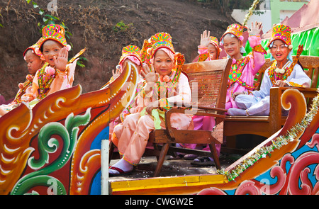 Les filles en costume font partie d'une procession pour les jeunes hommes entrer dans un monastère bouddhiste à KENGTUNG - Myanmar Banque D'Images