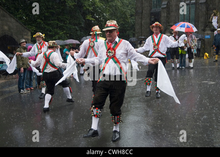 Pluie d'été d'août. La danse morris men pendant une tempête de pluie. Uppermill Tameside Yorkshire UK HOMER SYKES Banque D'Images