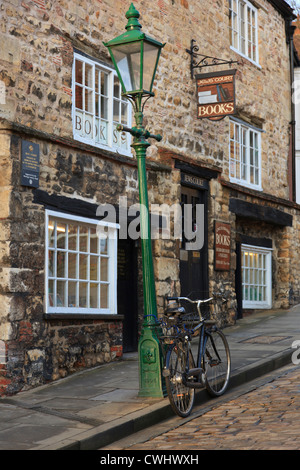 Location par une tendance lampadaire extérieur d'un vieux livre boutique dans quartier historique de ville de Lincoln, Lincolnshire, Angleterre, RU Banque D'Images