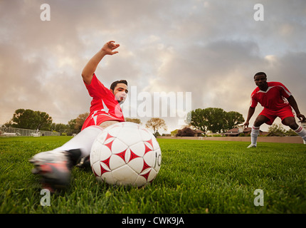 Hispanic soccer player Kicking the ball Banque D'Images