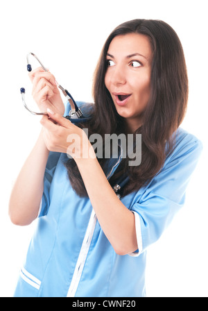 Silly à étonné ou surpris la femme en bleu uniforme avec phonendoscope isolé sur fond blanc Banque D'Images