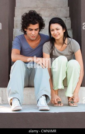 Young couple sitting on steps Banque D'Images