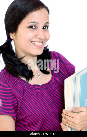 Smiling Indian female student holding books against white background Banque D'Images