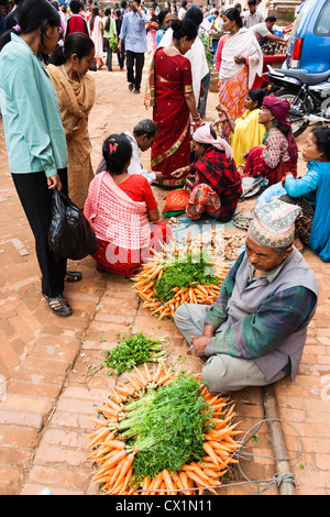 Newari homme vente de légumes à la place Taumadhi Tol . Bhaktapur , Vallée de Katmandou, Népal Banque D'Images