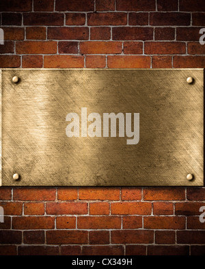 Ancienne plaque de bronze ou d'or sur mur de brique Banque D'Images