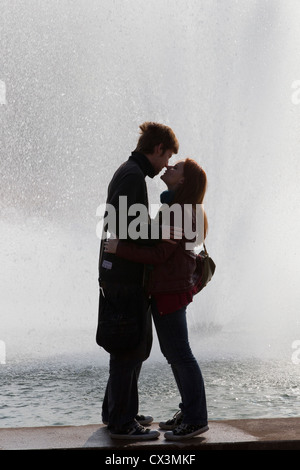 Jeune couple silhouetté contre fontaine Banque D'Images