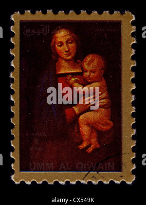 UMM-AL-QIWAIN-circa 1990:un timbre imprimé en UMM-AL-QIWAIN montre image de Vierge et l'enfant, vers 1990. Banque D'Images