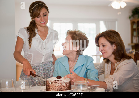 Une jeune femme au service de gâteau pour sa mère et sa grand-mère Banque D'Images