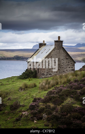 Sous un ciel orageux Crofters cottage avec vue sur le Loch Torridon Wester Ross ouest des Highlands en Écosse Banque D'Images