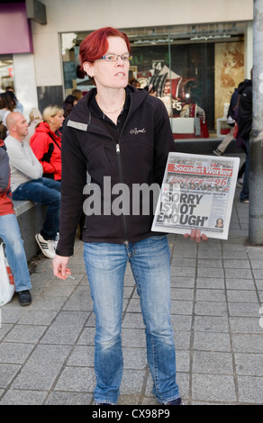 Femme vendant le journal Socialist Worker Hillsborough Justice titre pour Liverpool 96 1 Shopping Precinct Angleterre Banque D'Images