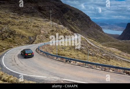 Une voiture descendant la route sinueuse qui mène Bealach na Ba, les Highlands écossais. Banque D'Images