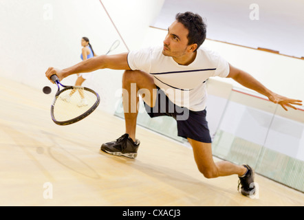 Hispanic couple playing squash Banque D'Images