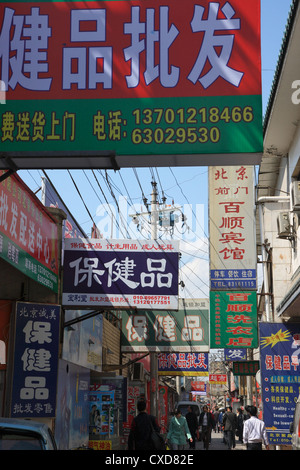 Beijing ruelle de la vieille ville avec de nombreux panneaux publicitaires Banque D'Images