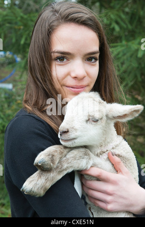 Teenage girl holding lamb Banque D'Images