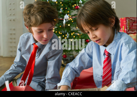 L'ouverture des cadeaux de Noël les garçons Banque D'Images