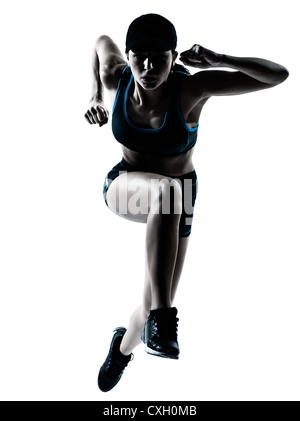 Un caucasian woman runner jogger sautant en silhouette studio isolé sur fond blanc Banque D'Images