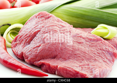 Filet de boeuf avec légumes crus comme closeup on white plate