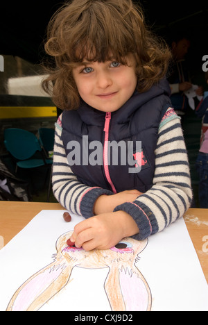 5 ans, fille d'un animal de dessin au masque une Commission forestière Journée Découverte, Alice Holt Forest, Farnham, Surrey, Royaume-Uni. Banque D'Images