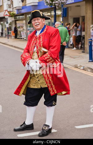 Crieur public dans un manteau rouge holding Bell Banque D'Images