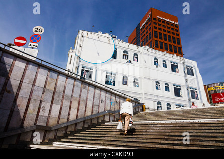 Femme sortant d'un passage piétonnier souterrain dans le centre de Lodz en direction de la rue Piotrkowska. Pologne Banque D'Images