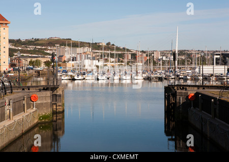 Bateaux amarrés dans le port de plaisance de Swansea voir à travers l'ouverture de la barrière de l'écluse Banque D'Images