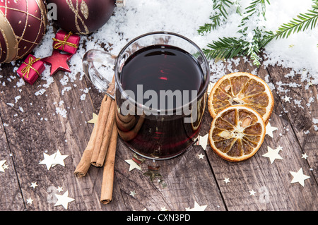 Verre à vin chaud épicé sur un fond couvert de neige Banque D'Images