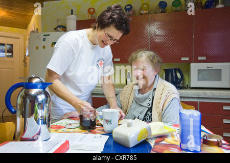 Les soins ambulatoires de l'infirmière de la Croix-Rouge allemande, Anke Lehmann préparer le petit-déjeuner pour une attaque cardiaque patient, Treuenbrietzen Banque D'Images