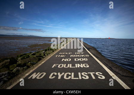 Peintures d'avertissements sur le sentier à West Kirby avec la rivière Dee à gauche et Marine Lake à droite, Wirral UK Banque D'Images