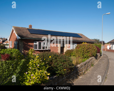 Des panneaux solaires photovoltaïques sur le toit d'un bungalow au bord de la mer Marske NorthYorkshire UK Banque D'Images