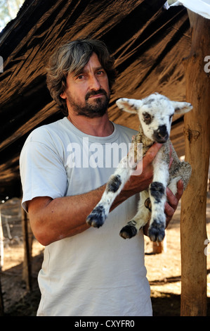Portrait d'un petit exploitant détenant un chevreau, kit, Gran Chaco, province de Santiago del Estero, en Argentine, en Amérique du Sud Banque D'Images