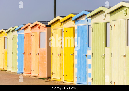 Une rangée de cabines de plage sur une plage de sable avec des dunes derrière Banque D'Images