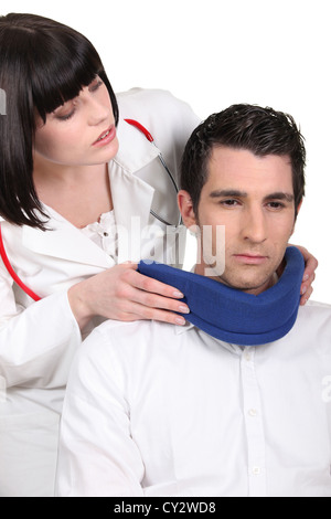 Doctor putting un neck brace sur son patient Banque D'Images