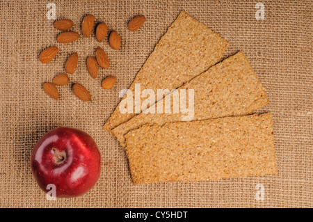 Pomme Rouge avec des biscottes et des amandes sur fond sac Banque D'Images