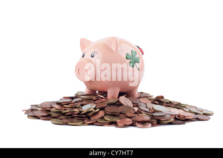 Pink Piggy Bank debout sur des crédits Isolated On White Banque D'Images