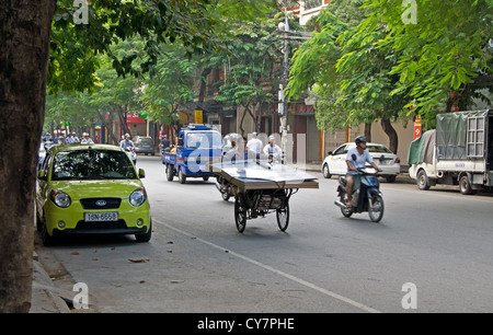 Un homme portant feuilles de bois sur son vélo panier à Hai Phong Vietnam Banque D'Images