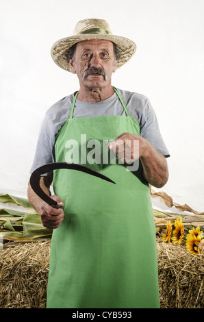 Agriculteur biologique avec une petite faucille d'herbe dans sa main Banque D'Images