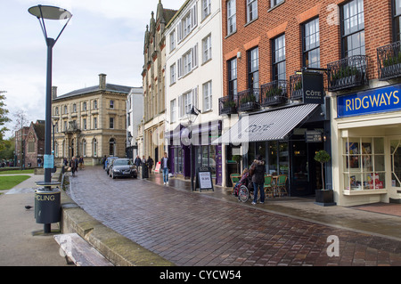 Le 31 octobre 2012. Près de la cathédrale d'Exeter, Devon, Angleterre. Shoppers par temps humide dans un centre-ville avec des bâtiments anciens et modernes Banque D'Images