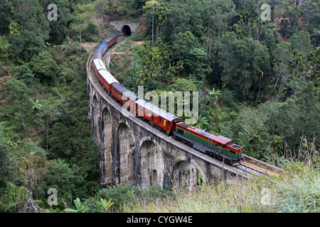 Le train de voyageurs de banlieue passant sur le pont en arc à Demorada neuf dans les hautes terres du Sri Lanka. Banque D'Images