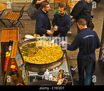 Les hommes la cuisson de la Paella sur la voiturette à Covent Garden, Londres Banque D'Images