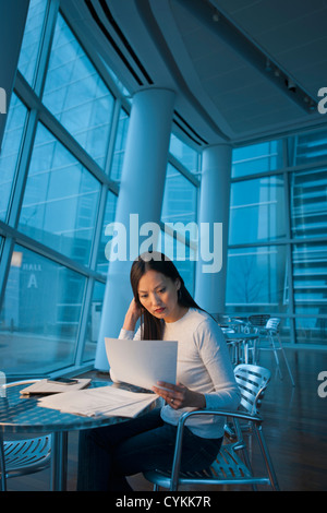 Asian businesswoman looking at paperwork Banque D'Images