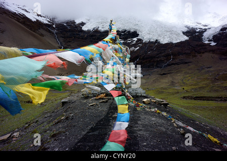 Drapeaux de prière bouddhiste en face du glacier, La Karo, pass, 5010 m, Tibet, Chine Banque D'Images