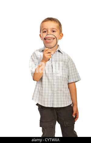 Happy kid holding une loupe pour montrer son grand sourire isolé sur fond blanc Banque D'Images