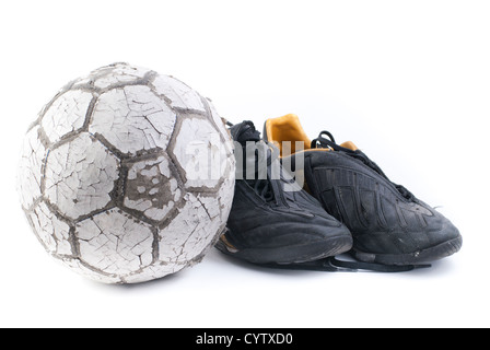 Ballon de soccer avec deux vieilles chaussures de football noir Banque D'Images