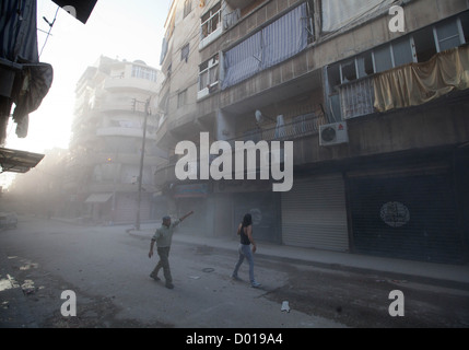 1 novembre 2012 - Alep, Syrie : Les gens réagissent à trois mortiers de feu dans un bâtiment et la route. Banque D'Images