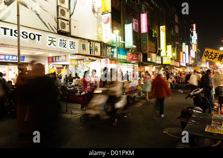 Une rue bondée scène montrant les panneaux d'éclairage sans fin et les gens la nuit shopping dans la rue du Marché de nuit de Huaxi touristiques, Wanhua District, Taipei Banque D'Images