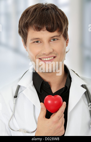 Doctor holding heart shape toy Banque D'Images