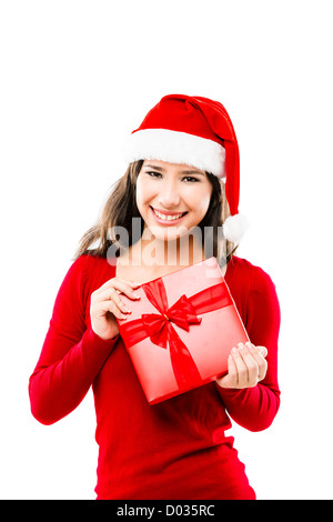 Beautiful Asian woman wearing Santa hat and holding a Christmas Gift, isolated on white Banque D'Images