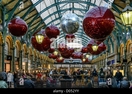 Shoppers à Noël décoré marché couvert de Covent Garden, Londres, Angleterre, RU, 2012 Banque D'Images