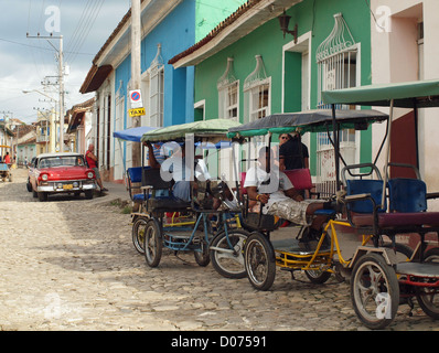 Les exploitants de taxi tricycle cubain attendre dans une scène de rue typique de Trinidad Cuba Banque D'Images